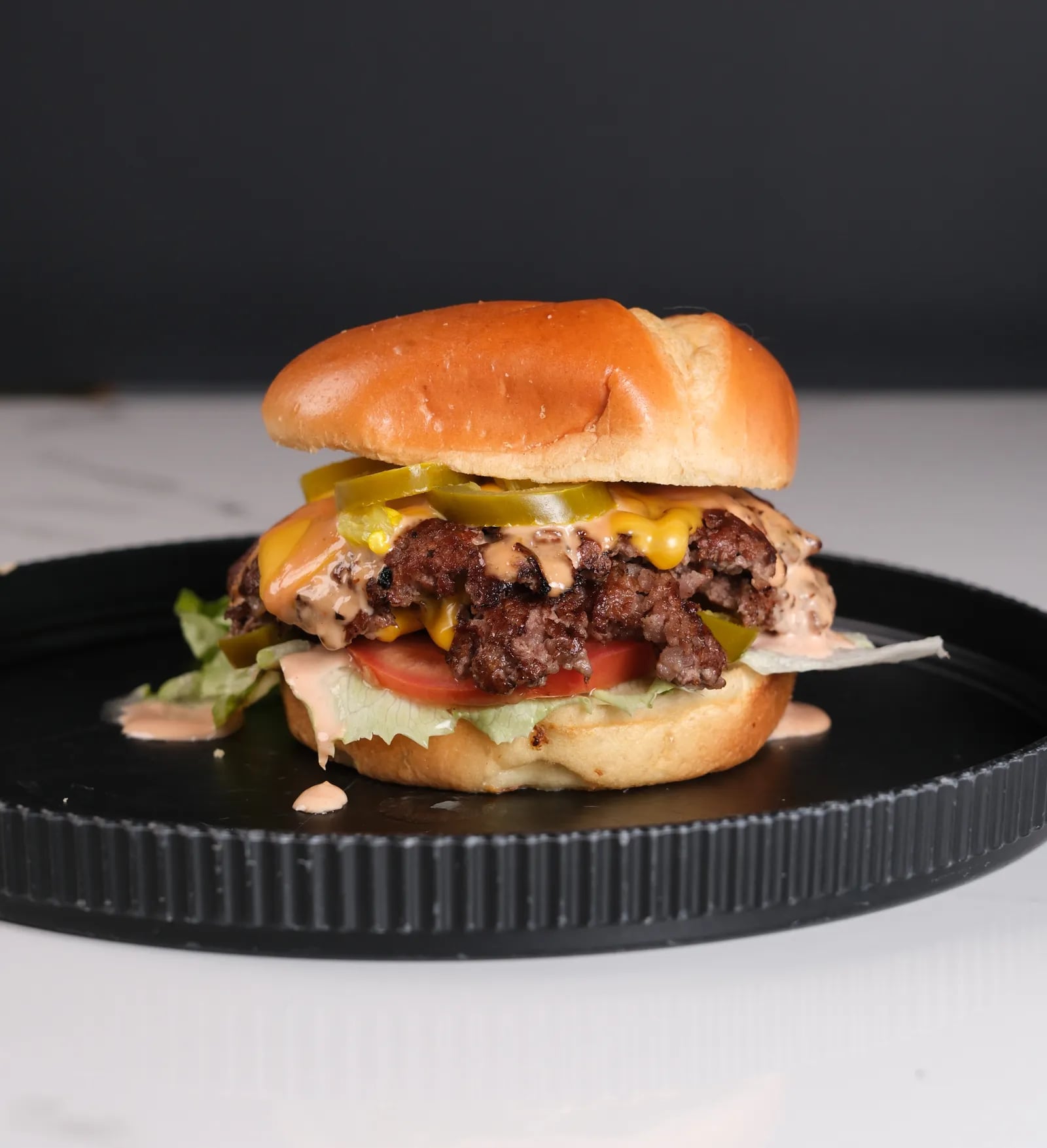 Flamin' Smash - Premium smash burger with spicy smashed beef, jalapeños, chipotle mayo, pepper jack, toasted brioche bun